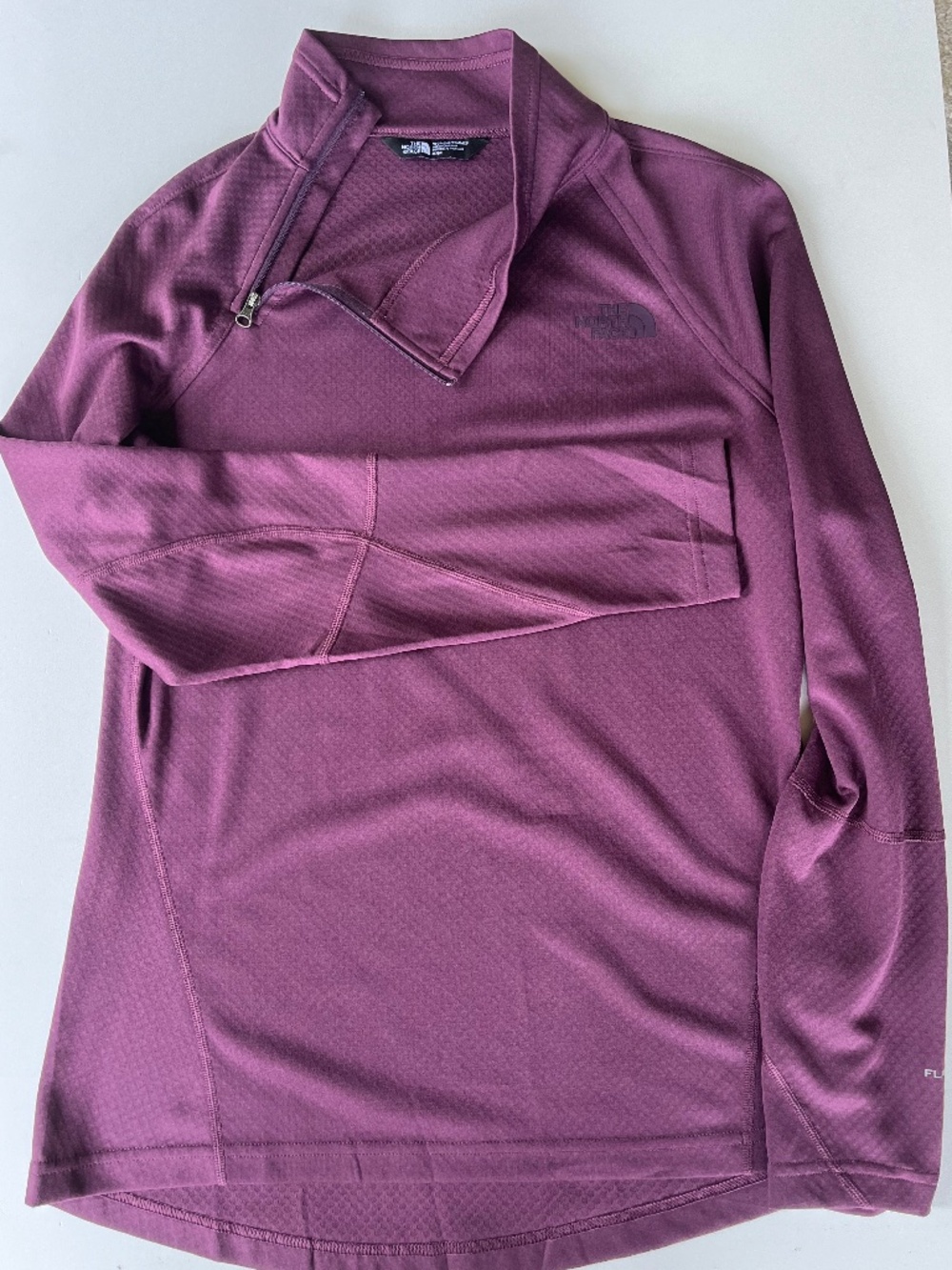 The North Face plum color long-sleeve quarter-zip pullover with a textured grid